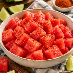 Sandía con limón verde y chile en polvo en un tazón